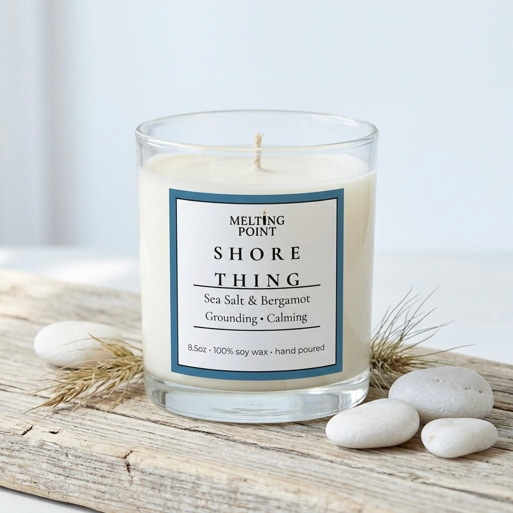 Shore Thing coastal cottage soy candle with salt air and sandalwood scent in a clear glass jar with seashells